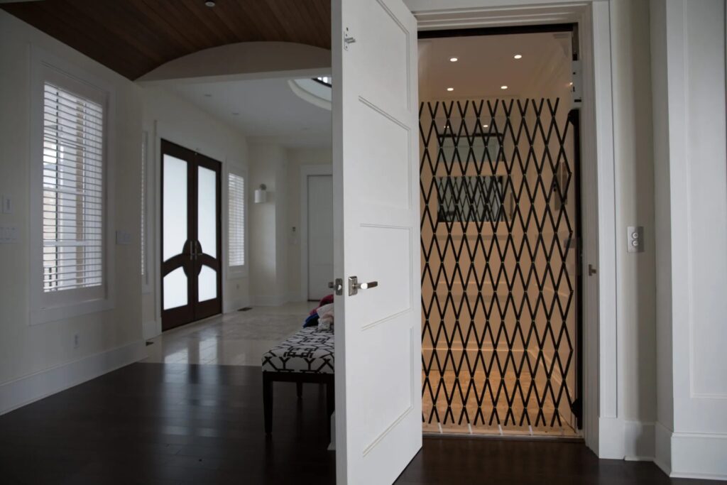 Delaware Elevator in a home with wooden door and metal gate