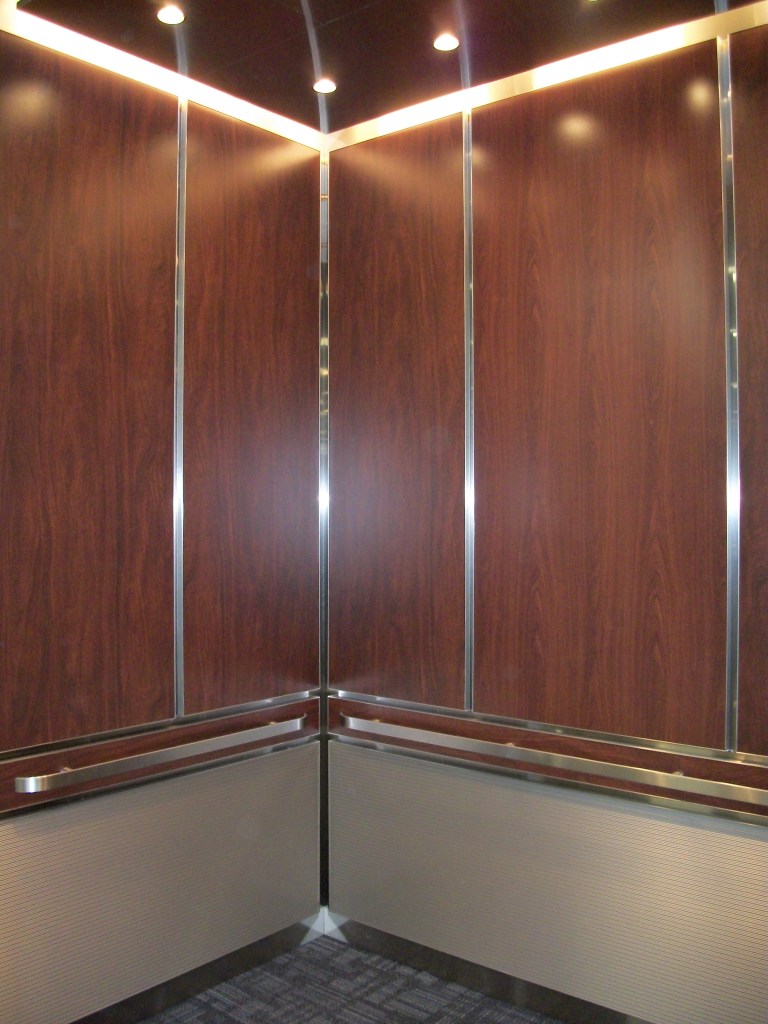 LU LA Elevator by Canton with wood paneling interior and metal accents